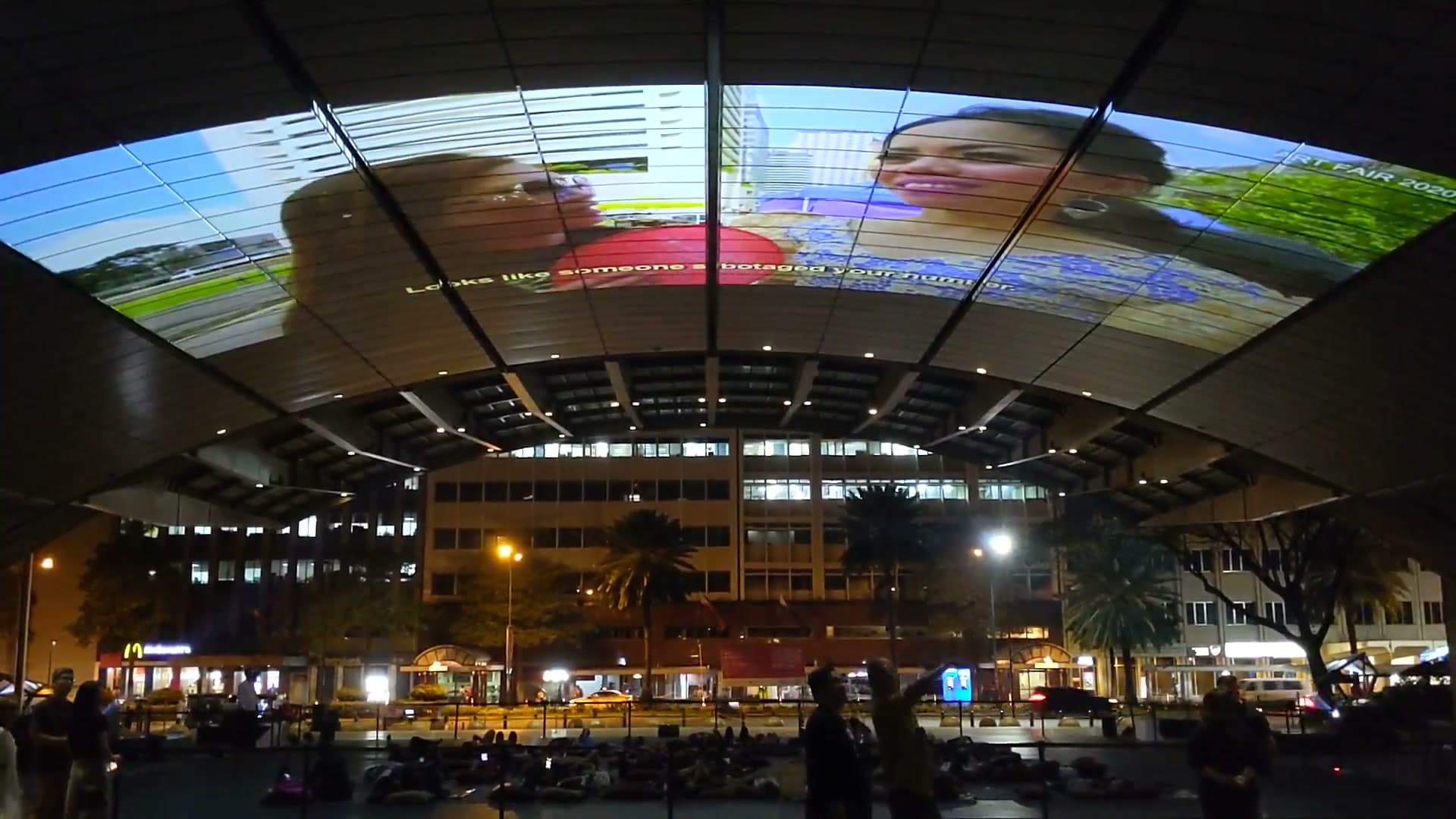 Outdoor cinema at Makati Stock Exchange dome with film projected on canopy